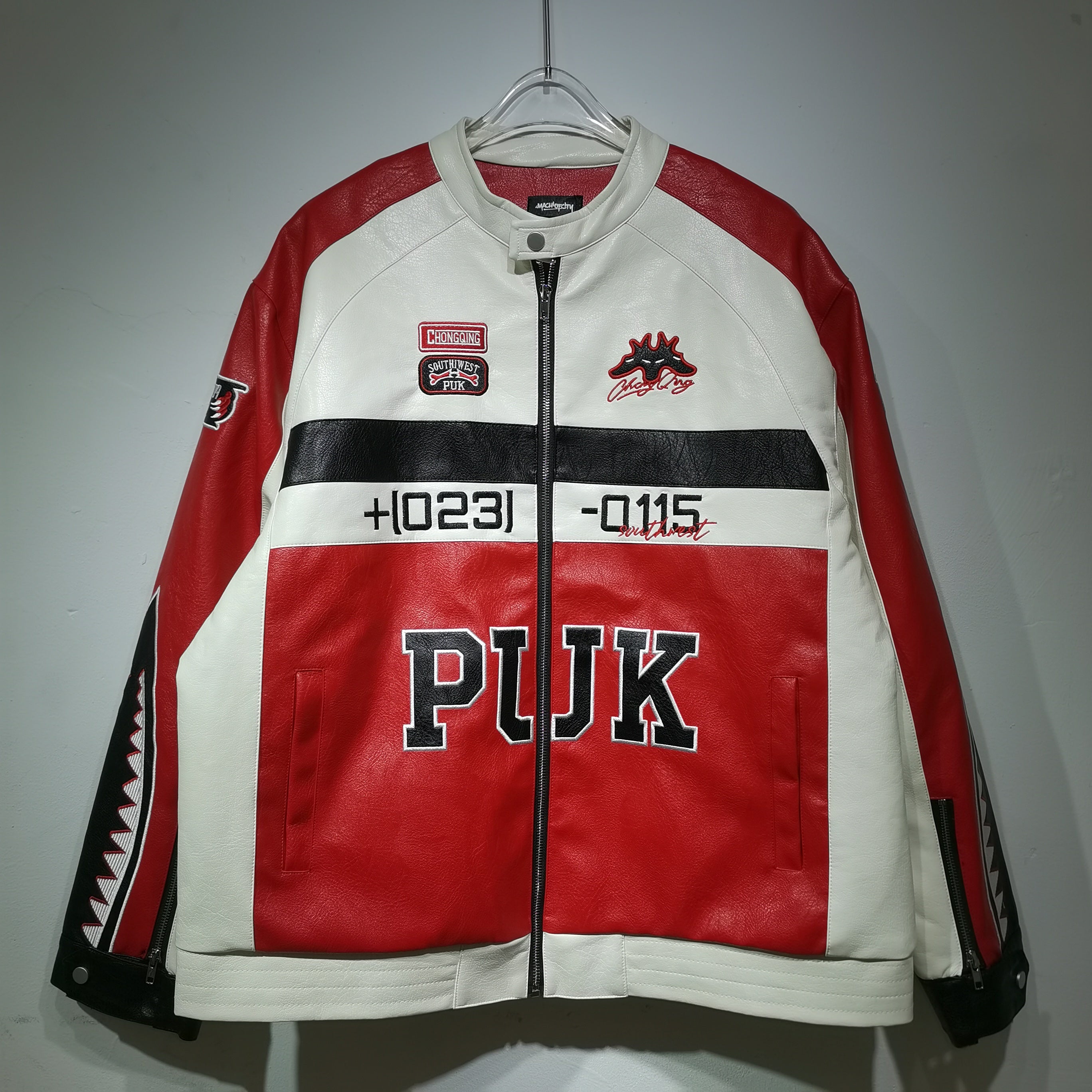 Red and white jacket with 'PUK' branding on a hanger against a gray background