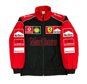 Black and red jacket with various sponsor logos on a gray surface