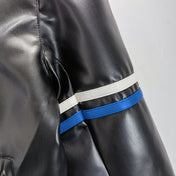 Close-up of a black leather jacket with blue and white striped cuffs on a gray background