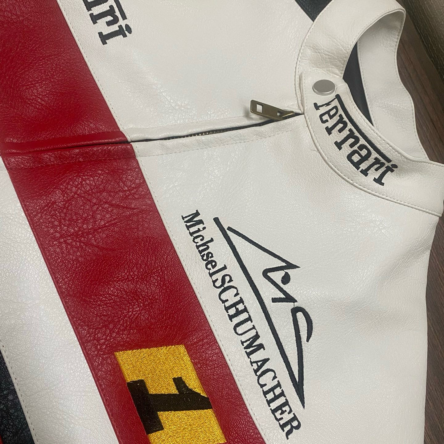 Close-up of a Ferrari racing suit with logos and text