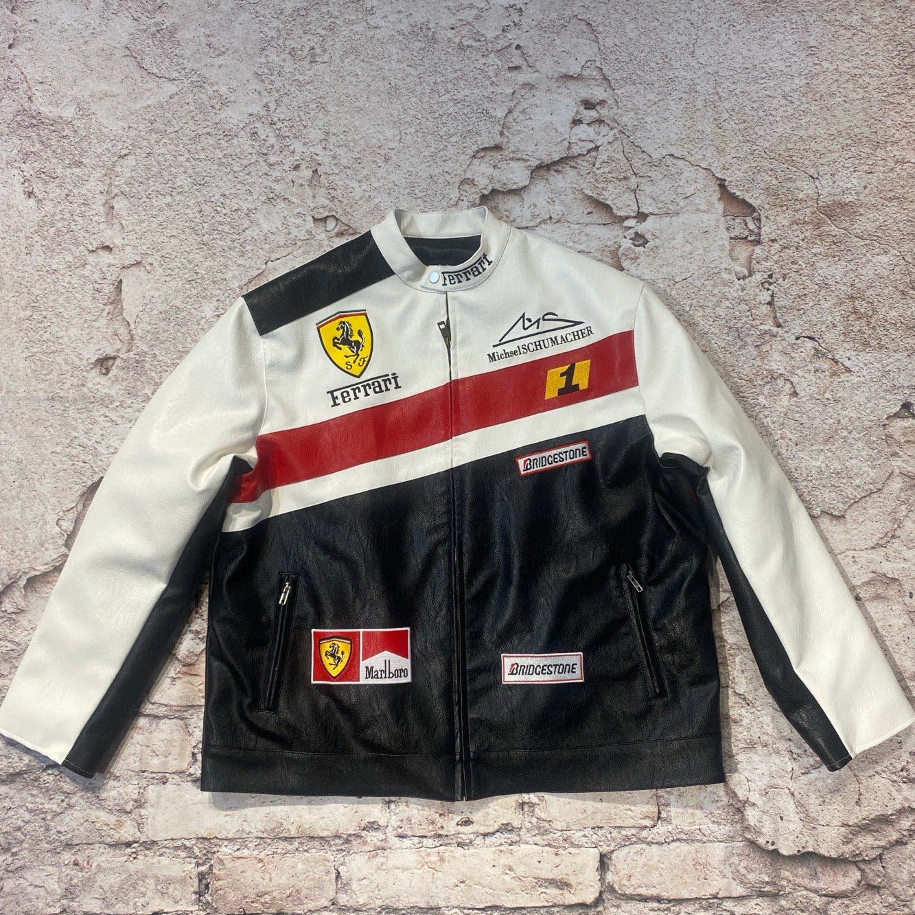 Race suit with Ferrari and other logos on a textured surface