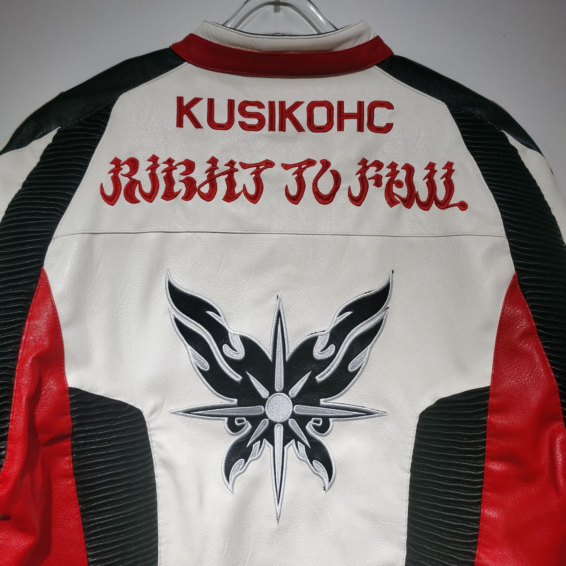 Leather jacket with red, black, and white design on a gray background