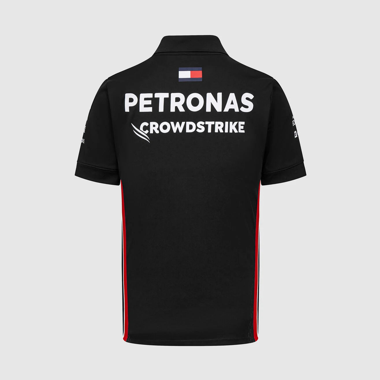 Black polo shirt with Petronas and CrowdStrike branding on a light gray background