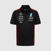 Black polo shirt with various logos on a light gray background