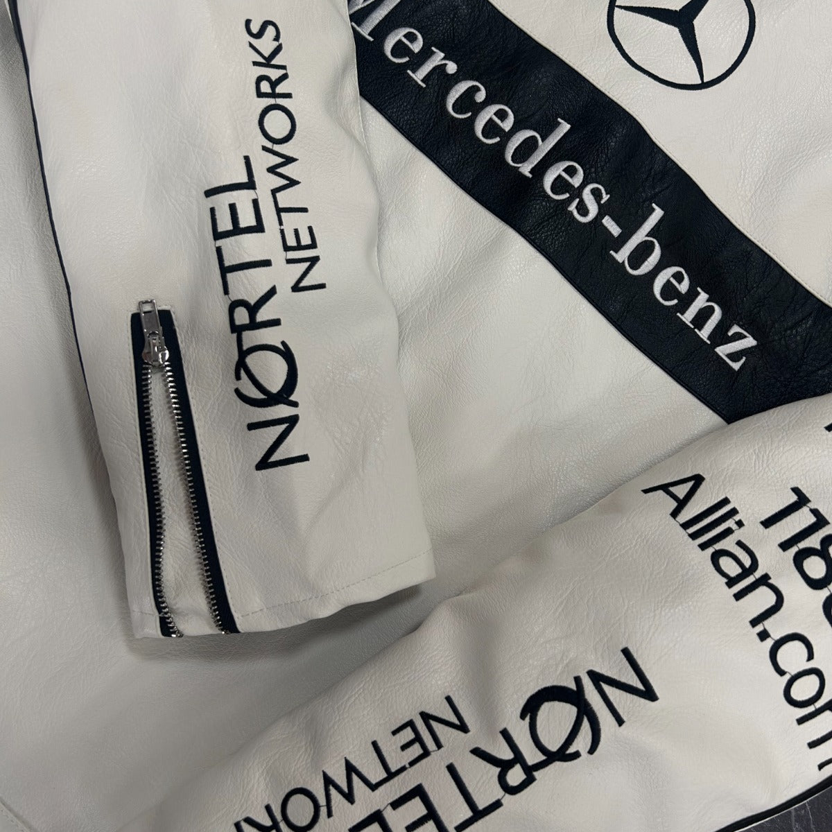 White bags with Mercedes-Benz and Nortel Networks branding on a white background