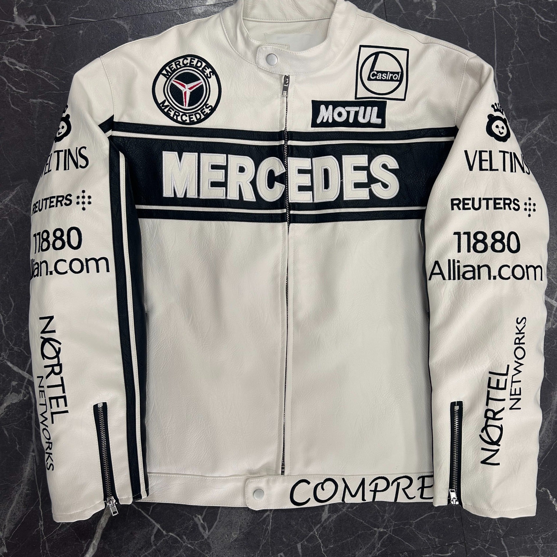 White leather jacket with Mercedes and Motul branding on a dark textured background