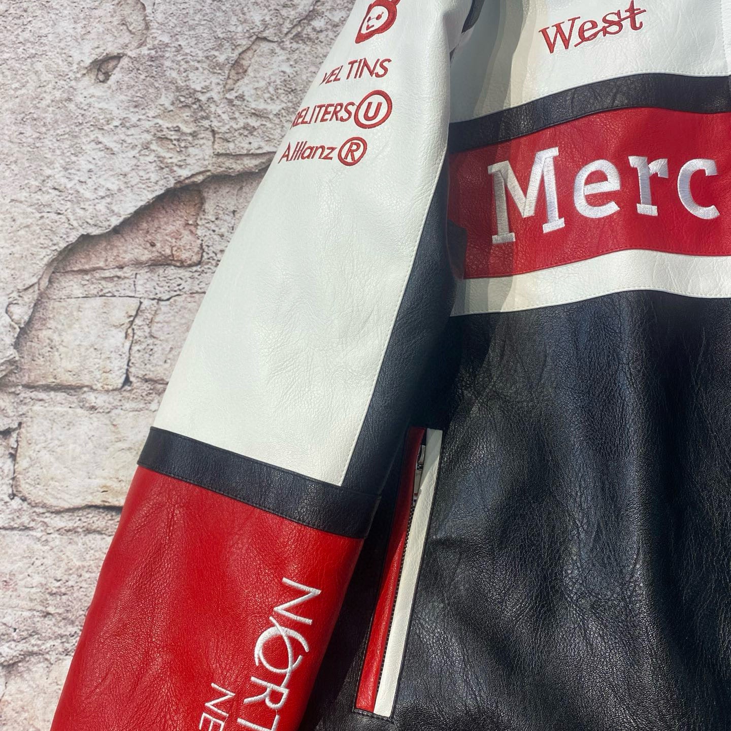 Close-up of a leather jacket with visible branding on a textured background