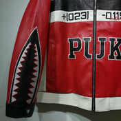 Red leather jacket with black and white accents and 'PUK' branding on a gray background