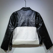 Black leather jacket with white quilted panel and 'Riders' embroidery on a gray background